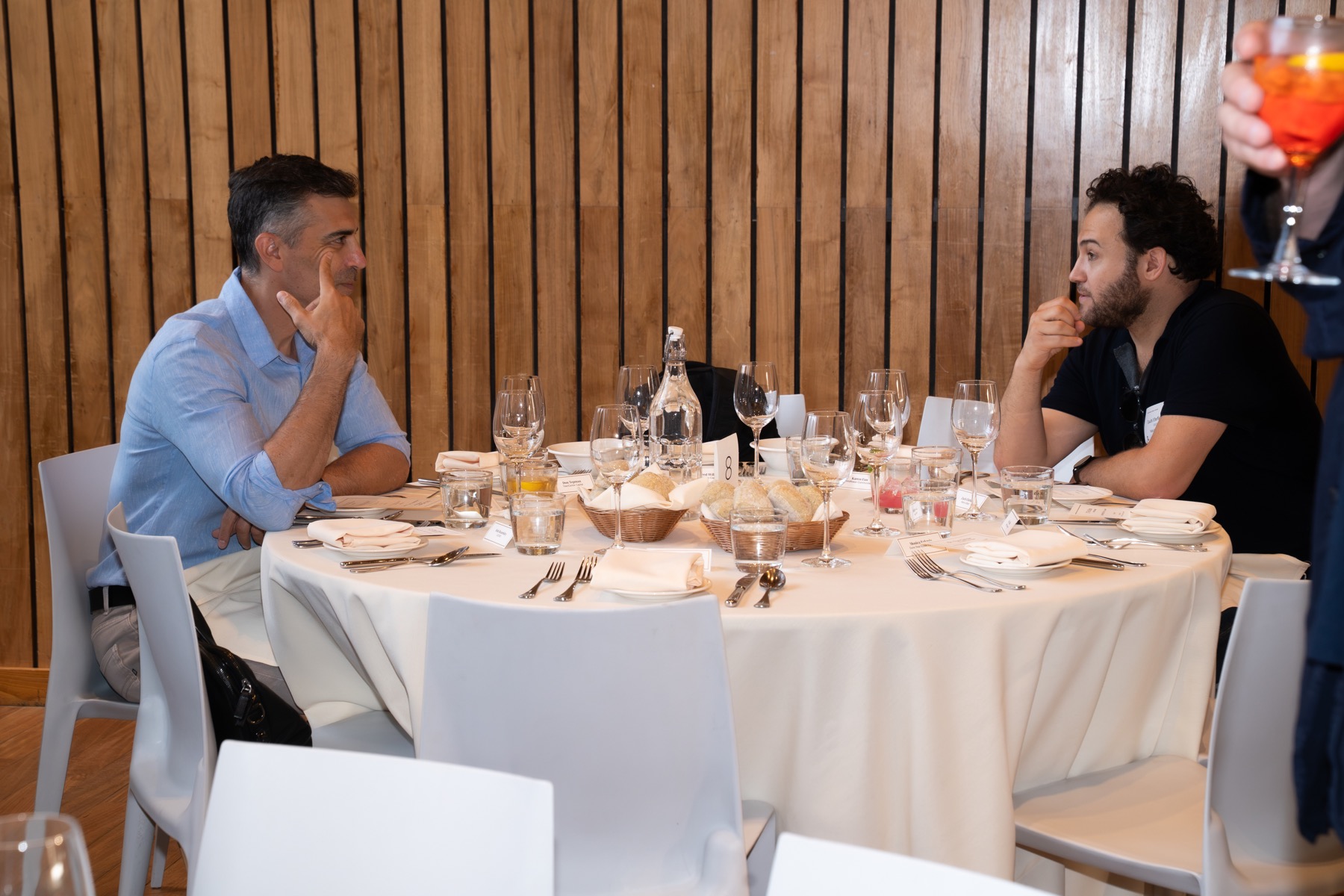 Two guests in conversation at an event table