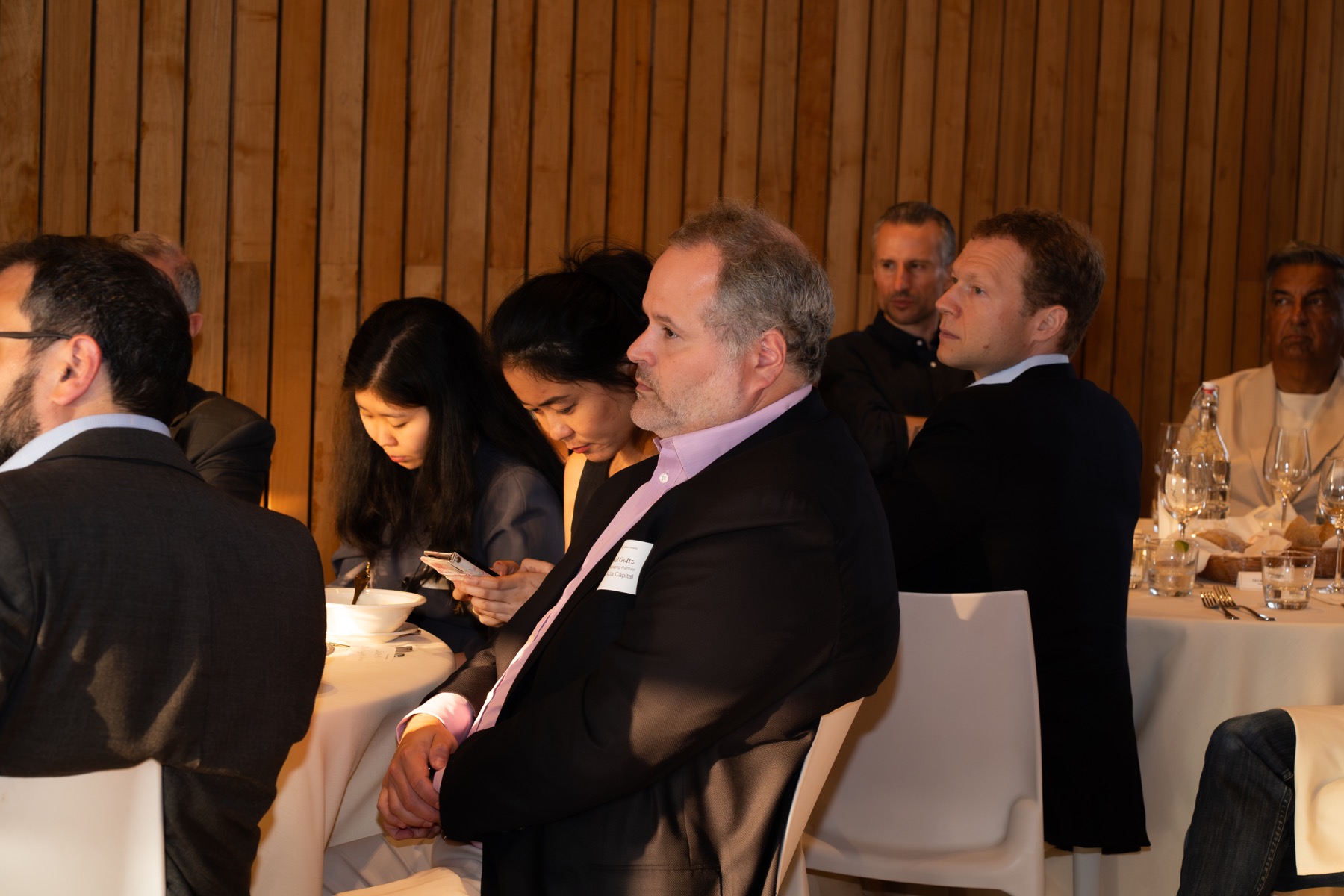 Corporate event guests seated for a dinner program