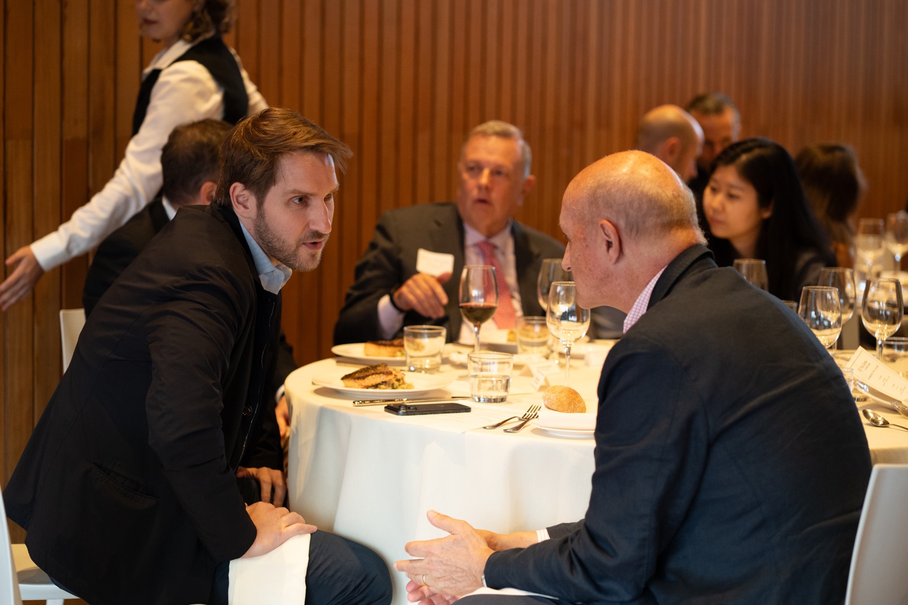 Guests in conversation during a dinner event