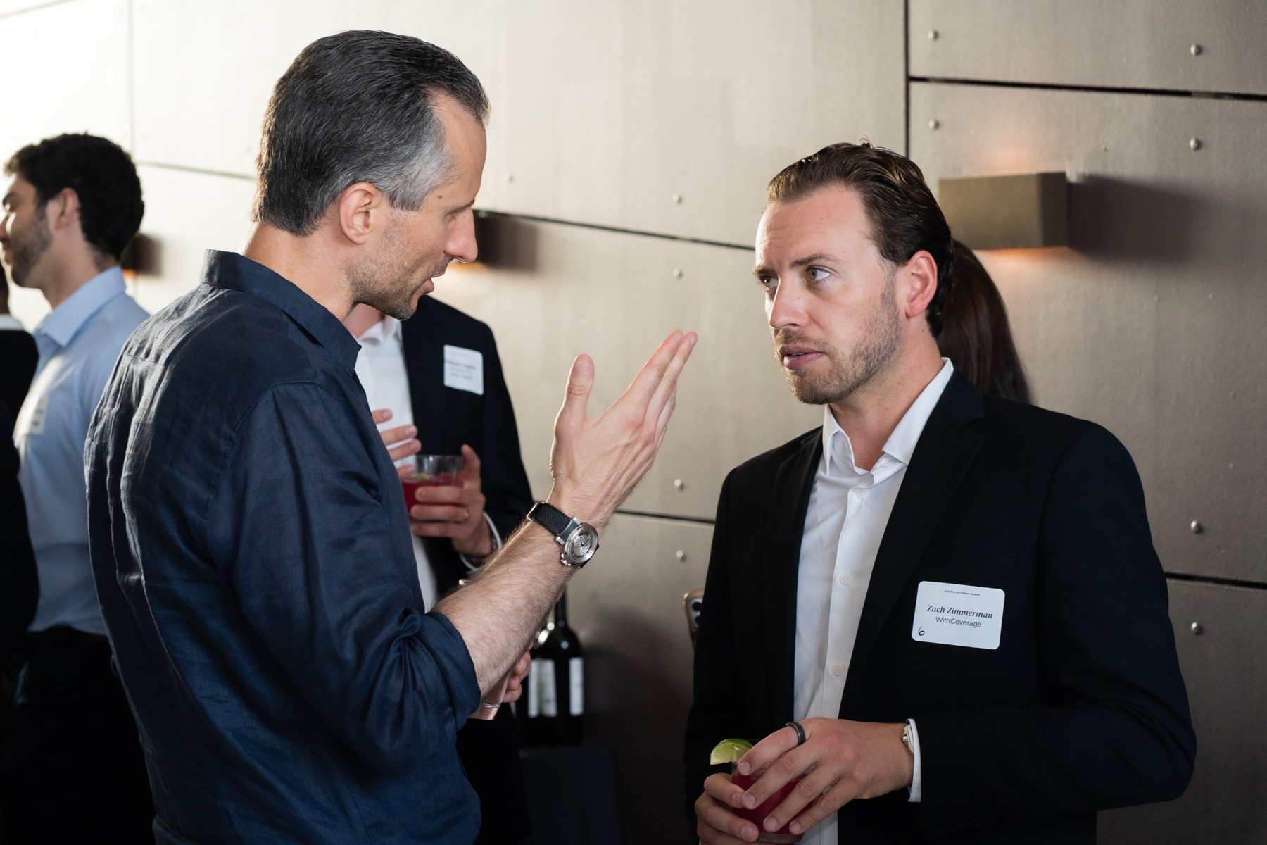 Two guests speaking during a professional reception