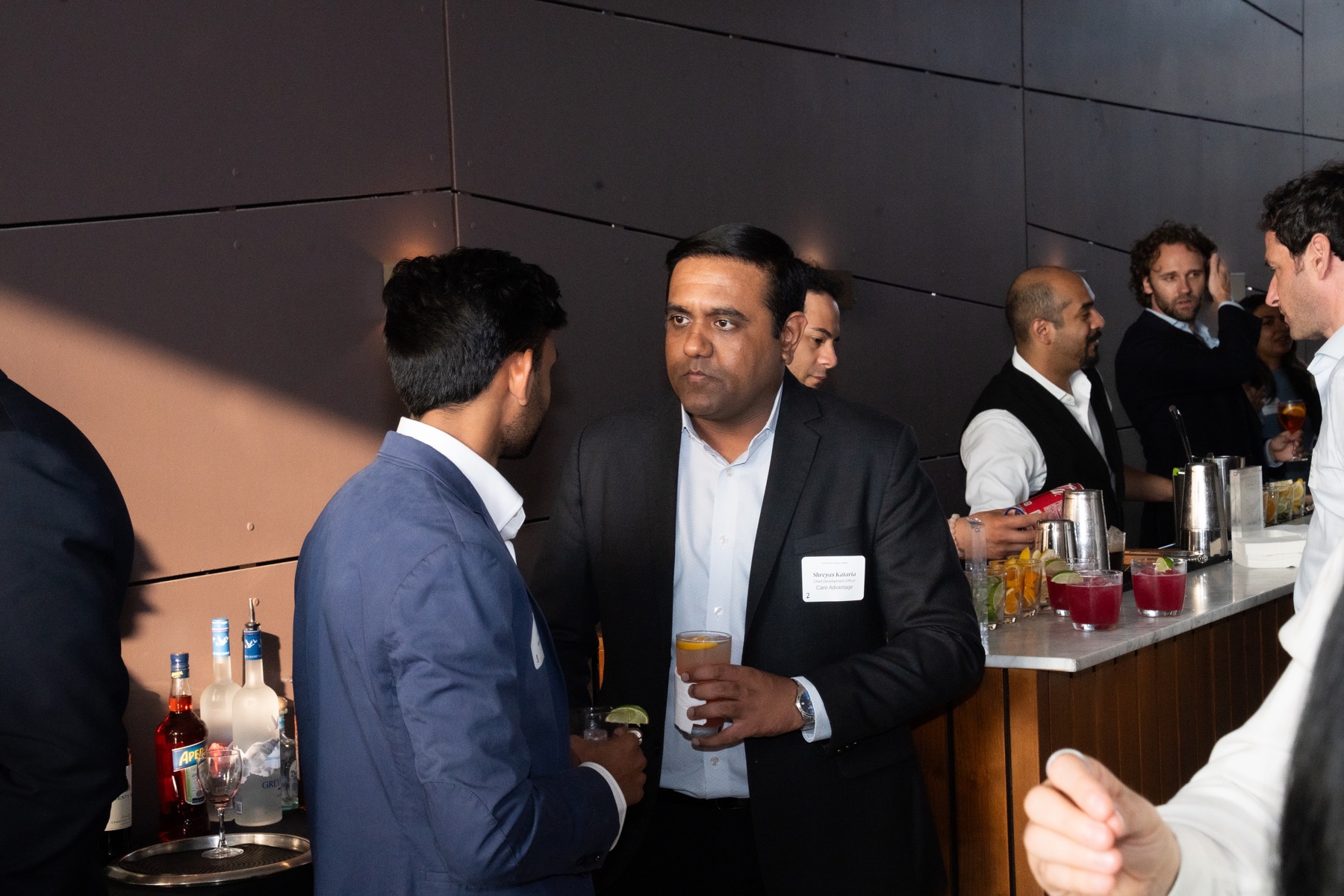 Guests conversing at a cocktail service station