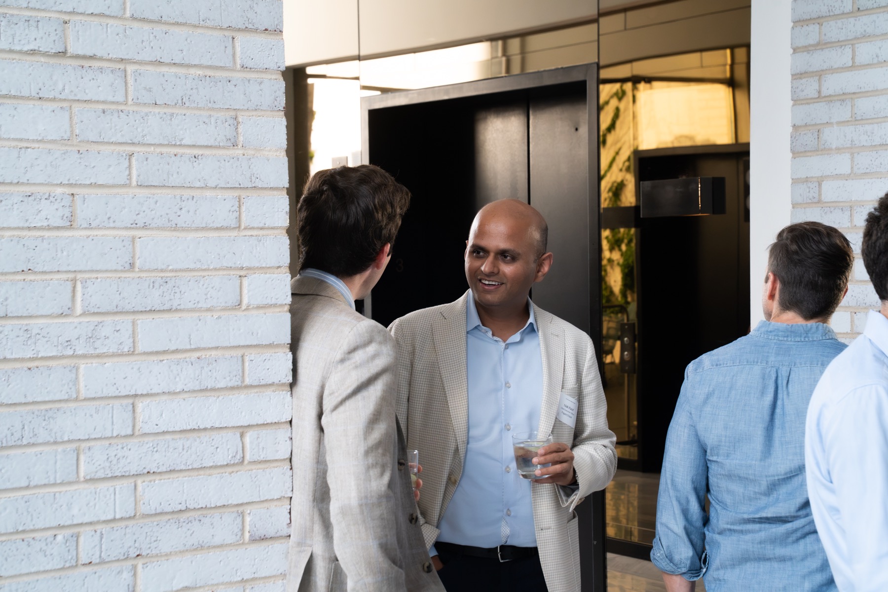 Guests arriving and networking near an event entrance